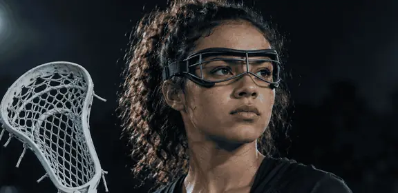 Lacrosse player in goggles holding a stick