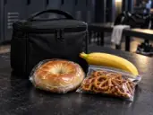 PACK TONIGHT: Packed bagel, banana and pretzels beside a lunch bag